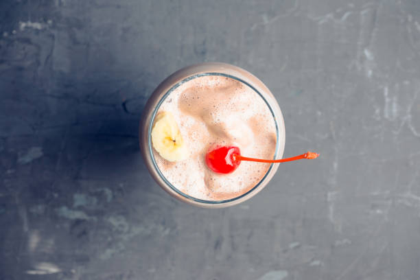 istock Chocolate milkshake with bananas and cherry on the rustic background 1125212748