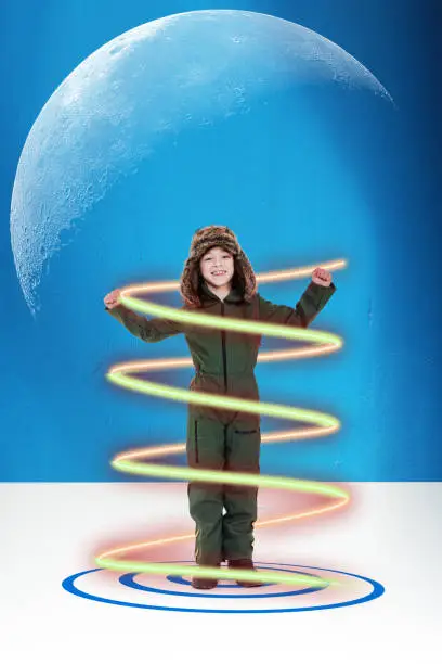 Cheerful cute smart kid imagining that he is traveling through time, Creativity and child game, Space for text