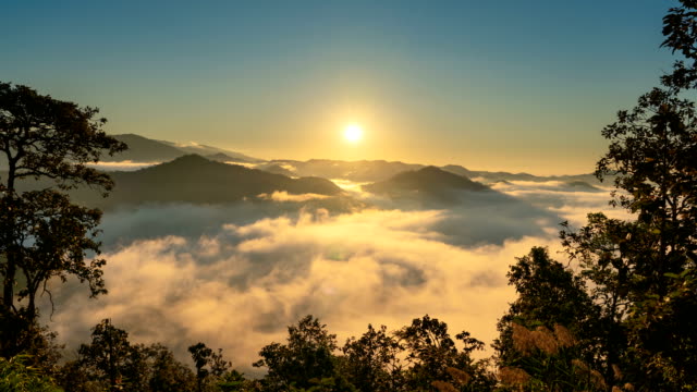 タイのチェンマイの霧と霧の雲と木のフレームと山の上のタイムラプス日の出