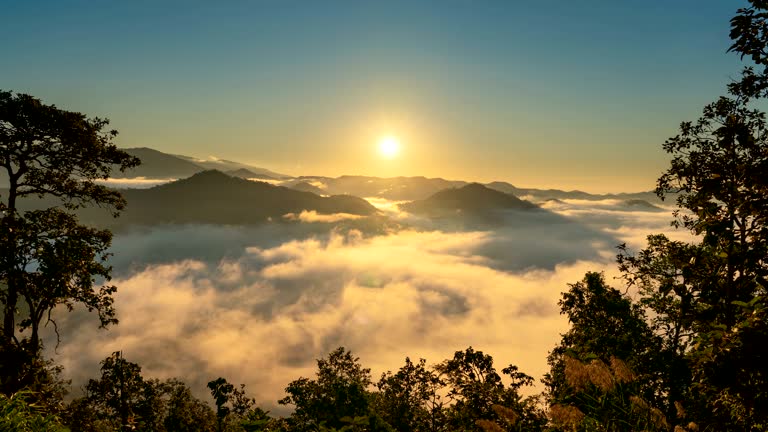 Time lapse Sunrise over mountain with mist and fog cloud