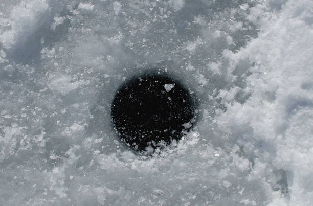 Hole for winter fishing in the afternoon