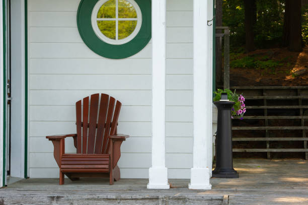 istock Adirondack chair sit on a cottage porch 1125219890