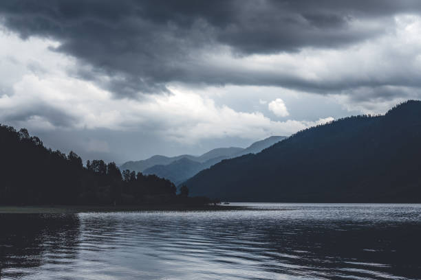 istock lake, mountains and forest in overcast gloomy weather 1125228564