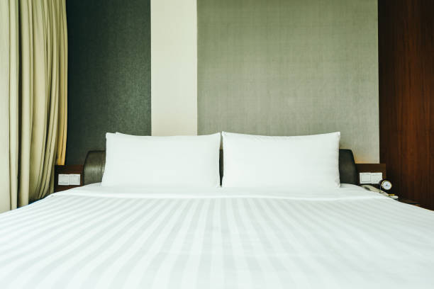 istock White pillow on bed decoration in bedroom interior 1125234838