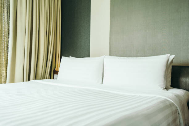 istock White pillow on bed decoration in bedroom interior 1125234938