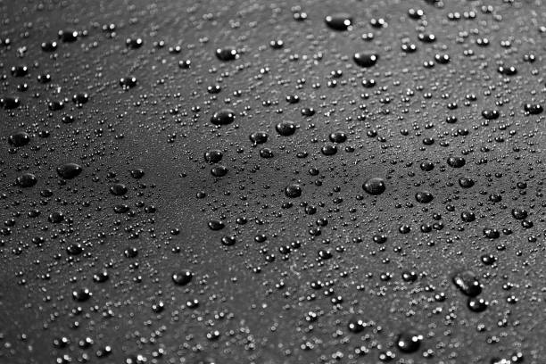 istock water drops on a black metal surface 1125239043