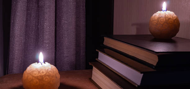 istock books on the table lit with night lights and candles 1125244158