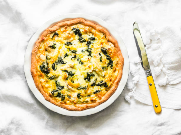 istock Spinach, leek, chicken, cheese pie on light background, top view 1125249345