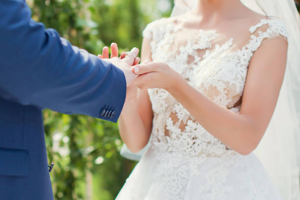 istock Bride and groom exchanging rings 1125249426