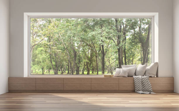 Side window seat with nature view 3d render. Side window seat 3d render.There are white room,wood seat,decorate with many pillow.There are big  windows look out to see nature view. looking through window stock pictures, royalty-free photos & images
