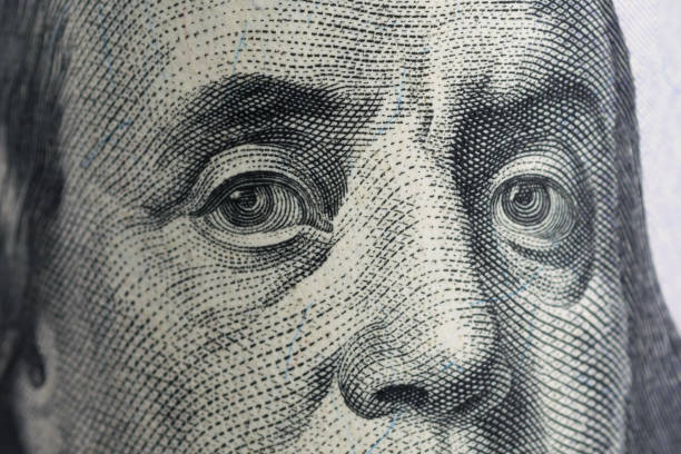 istock face with eyes on a hundred dollar bill close up, background 1125259219