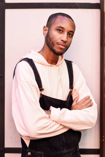 istock Young African guy with bib pants outdoors 1125261087