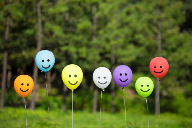 istock multicolored balloons floating in the green forest. 1125268333