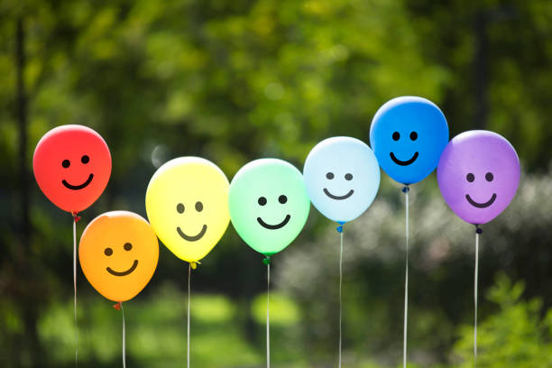istock multicolored balloons floating on the forest. 1125268400