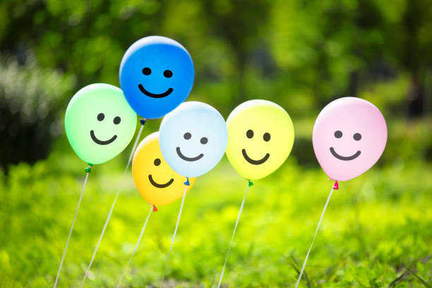 istock multicolored balloons in the green forest. 1125268427