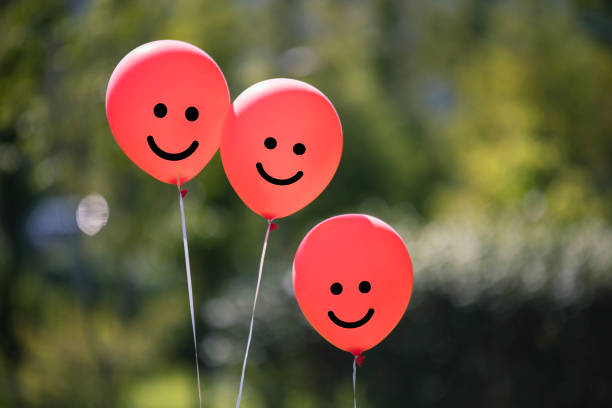 istock red colored air balloons floating in the forest. 1125268561