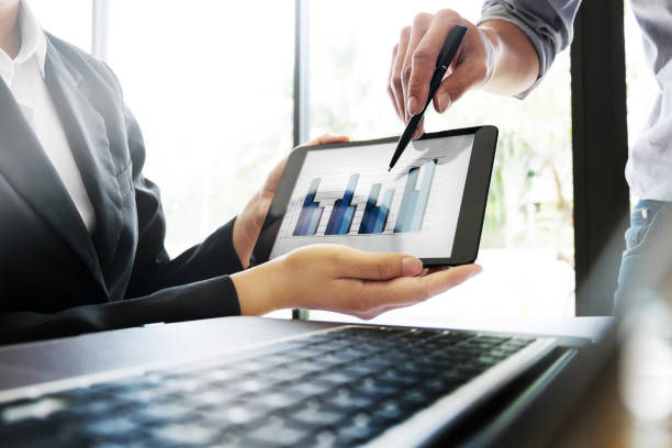 istock Business people meeting discussing on digital tablet with data graph 1125271196