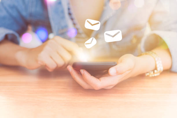 istock Woman hand using smartphone with email  icon pop up recieve and send notification on screen of mobile phone. Business communication technology concept. 1125272430
