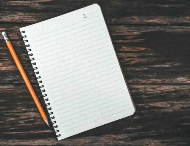 Photo of Notepad with yellow pencil