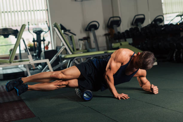 istock Young fit man rolling on a floor in the gym 1125283235