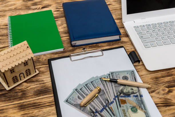 istock House model with dollars, laptop and clipboard 1125283742