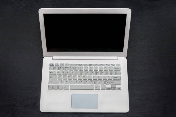 istock White laptop isolated on black top view 1125285931