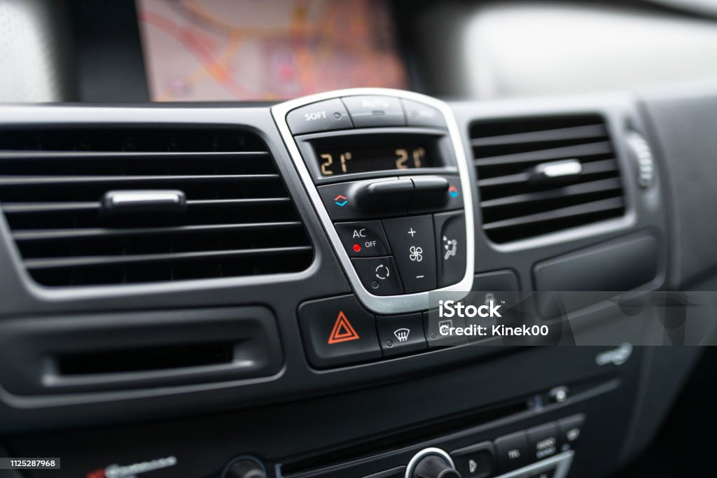 Car dashboard interior of modern car. Black cockpit with button and icon for air conditioner option, car window heating buttons and emergency lights button. Car Stock Photo