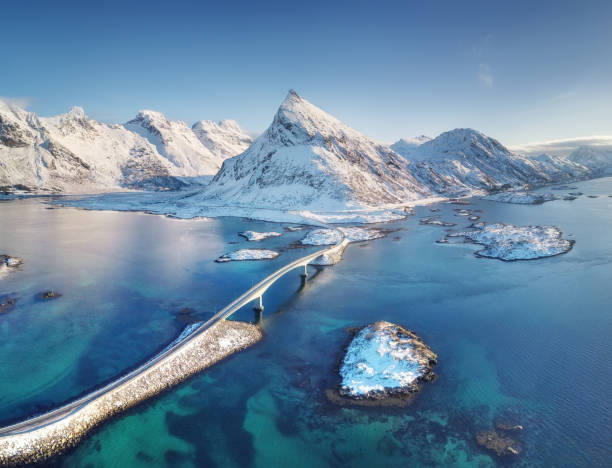 Aerial view on the Lofoten islands, Norway. Natural landscape from drone. Bridge adove islands. Aerial landscape from air in the Norway. Norway-image Aerial view on the Lofoten islands, Norway. Natural landscape from drone. Bridge adove islands. Aerial landscape from air in the Norway. Norway-image snow sunset winter mountain stock pictures, royalty-free photos & images
