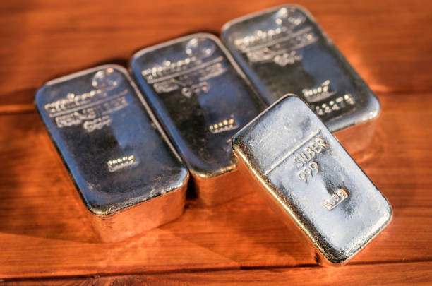 istock Four cast silver bullion on a mahogany background. 1125289784