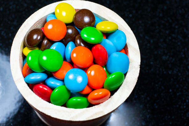 colorful chocolate coated candy in the wood box. - candy coated imagens e fotografias de stock