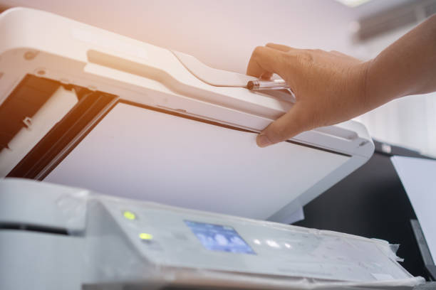 istock Business office Concept : Hand person employed open press button on panel of printer for process paperwork on laser print cartridge, lay down or take papers from laser copy machine at Busy Offices. 1125294575
