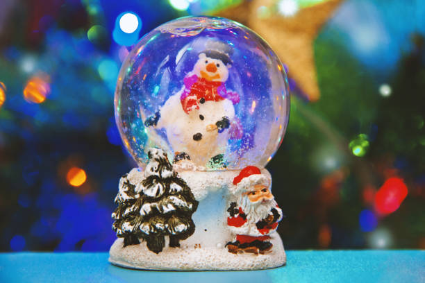 istock Christmas snow globe with Christmas tree lights background 1125296878