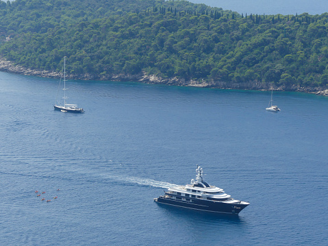 Otok Lokrum island, Croatia - August 3 2018: high panoramic view of luxury yachts around Otok Lokrum island near Dubrovnik