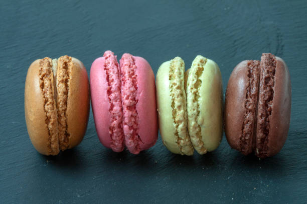 istock Macaroons of different colors in bulk presented on a slate background 1125297239