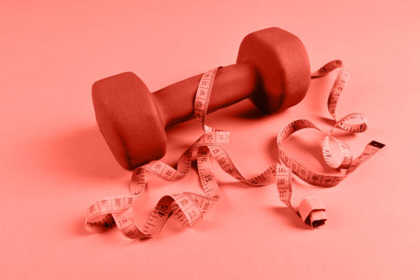istock Blue dumbbell and meter on orange background 1125299310