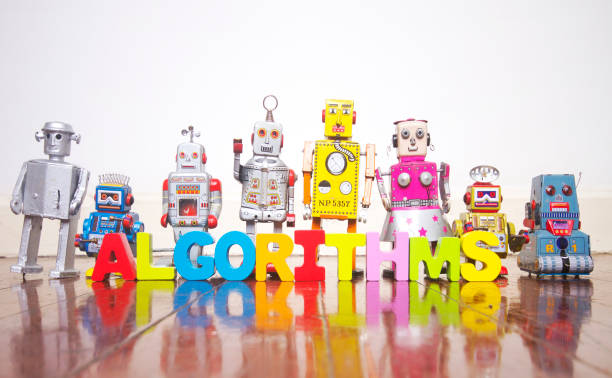 istock a line of retro robots on a wooden floor with the word ALGORITHMS 1125300028
