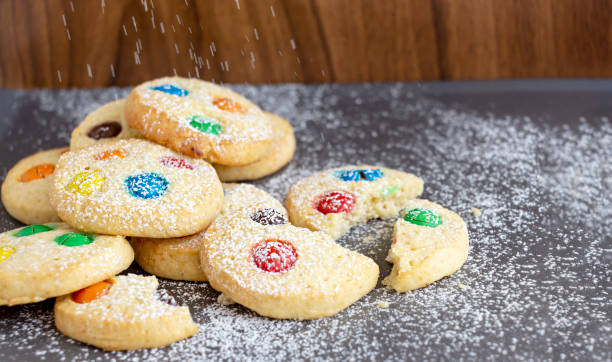 istock Homemade shortbread cookies with multicolored chocolate chips and icing powdered on gray background. Selective focus. Christmas concept. Copy space. 1125301398