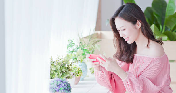 istock asian woman play mobile game 1125301660