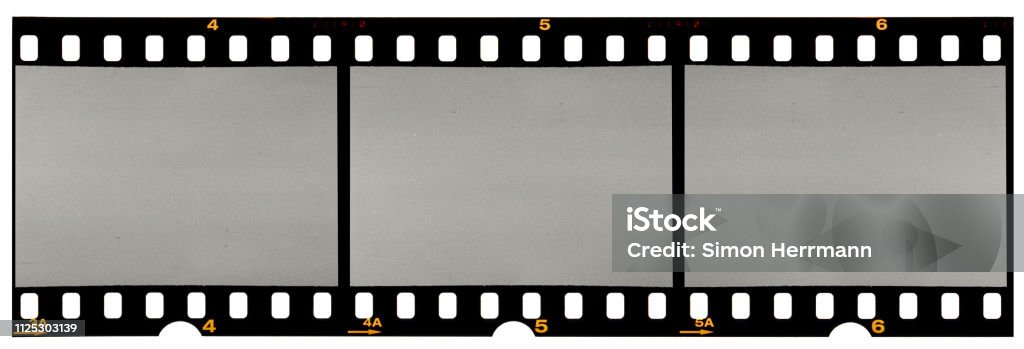 long film strip, blank photo frames, free space for your pictures, real high-res 35mm film strip scan with signs of usage on white background real long 35mm film strip or material on white Camera Film Stock Photo