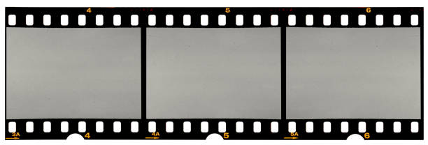 long film strip, blank photo frames, free space for your pictures, real high-res 35mm film strip scan with signs of usage on white background real long 35mm film strip or material on white rolling photos stock pictures, royalty-free photos & images