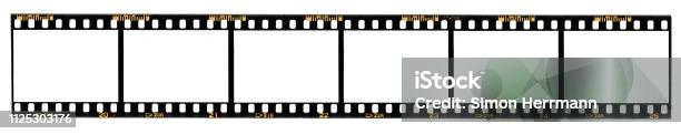 Long Film Strip Blank Photo Frames Free Space For Your Pictures Real Highres 35mm Film Strip Scan With Signs Of Usage On White Background Stock Photo - Download Image Now