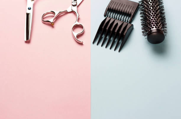 istock Scissors and comb on a pink and blue background, copy space 1125305365