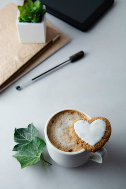 istock Flat lay of work desktop with coffee cup or latte, notepad with notebook. Education and business concept. 1125306401