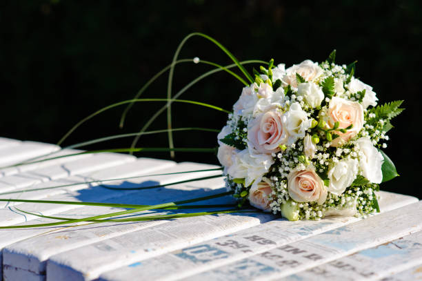 istock Bouquet of a bride on a white bench. Beautiful wedding bouquet. 1125310477
