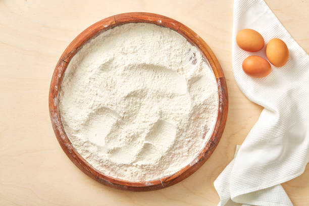 istock Raw egg and flour on wooden table. 1125312132