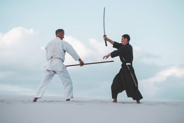 istock Two men practicing Japanese martial arts in desert 1125312301