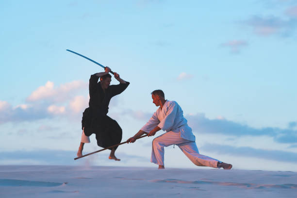 istock Concentrated men, in Japanese clothes, are practicing martial arts 1125312317