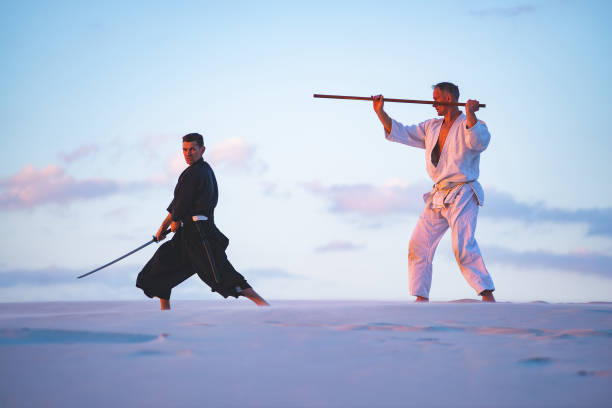 istock Concentrated men, in Japanese clothes, are practicing martial arts 1125312329