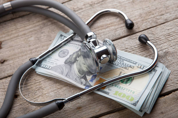 concetto di assicurazione sanitaria - stetoscopio sul denaro - currency stethoscope healthcare and medicine savings foto e immagini stock