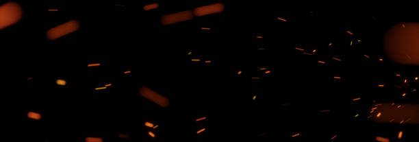 flying sparks from fire in front of black backgound